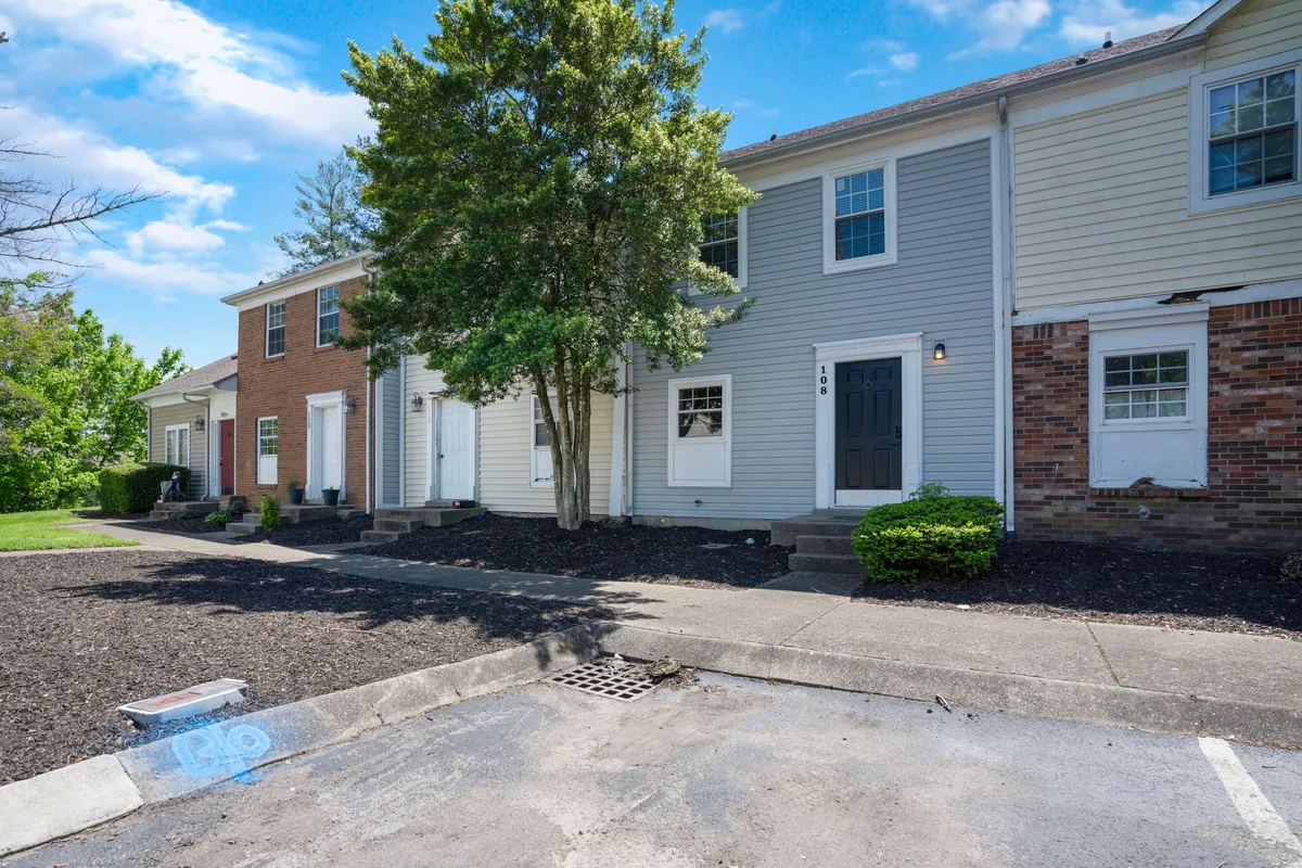 This exterior image features the front entrance of the Green Retreat, highlighted by an inviting front door, landscaped area, windows, and steps leading up to the home. The scene suggests a welcoming environment suitable for family gatherings or quiet, relaxing moments.